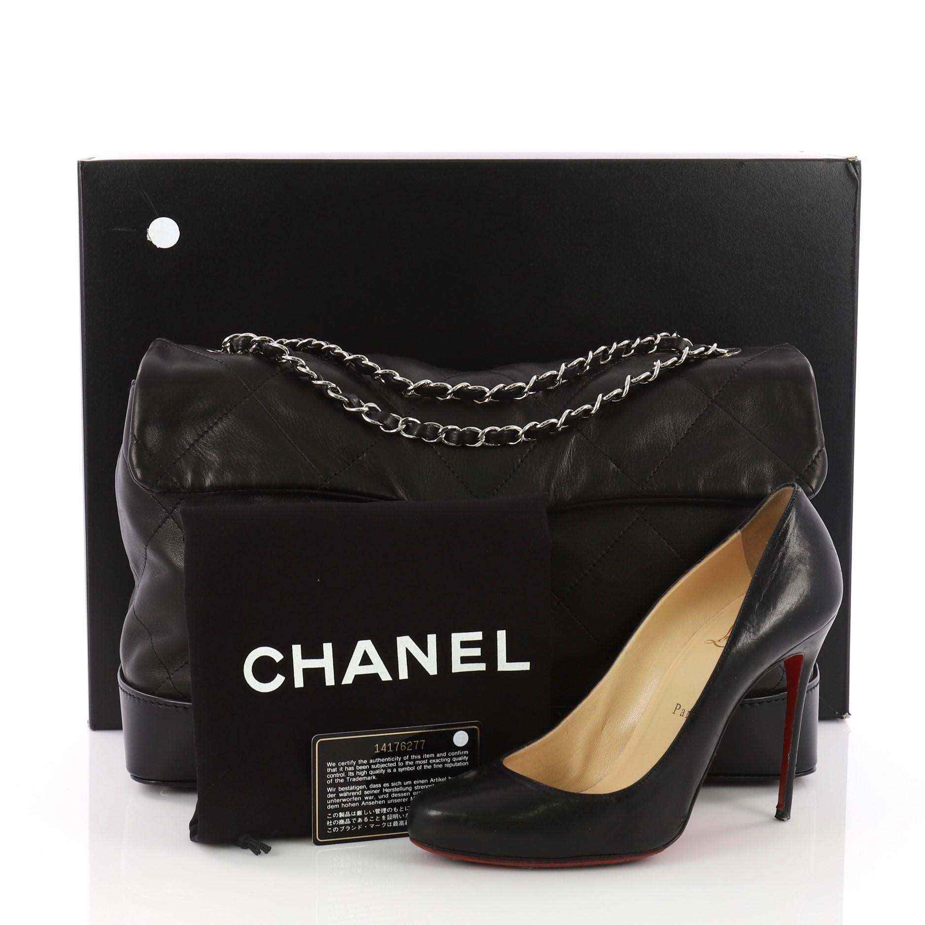This authentic Chanel VIP Flap Bag Quilted Lambskin Large is a versatile sleek style that will complement a multitude of looks. Crafted in black quilted lambskin, this bag features woven-in-leather chain strap, Chanel CC logo and silver-tone