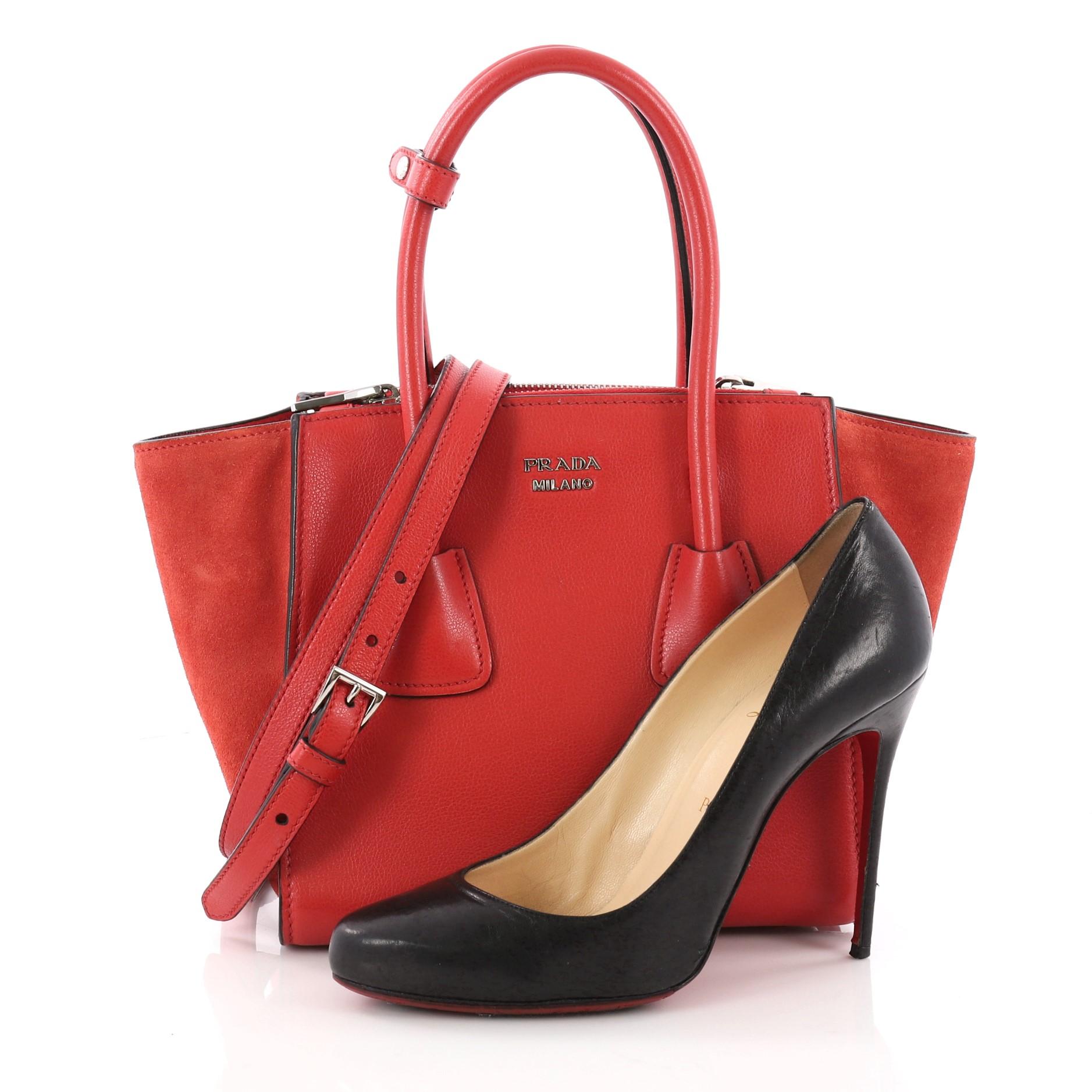 This authentic Prada Twin Pocket Tote Glace Calf and Suede Mini showcases a sophisticated silhouette balancing modern luxury and style perfect for the on-the-go woman. Crafted from red glace calf leather and suede, this boxy tote features tall