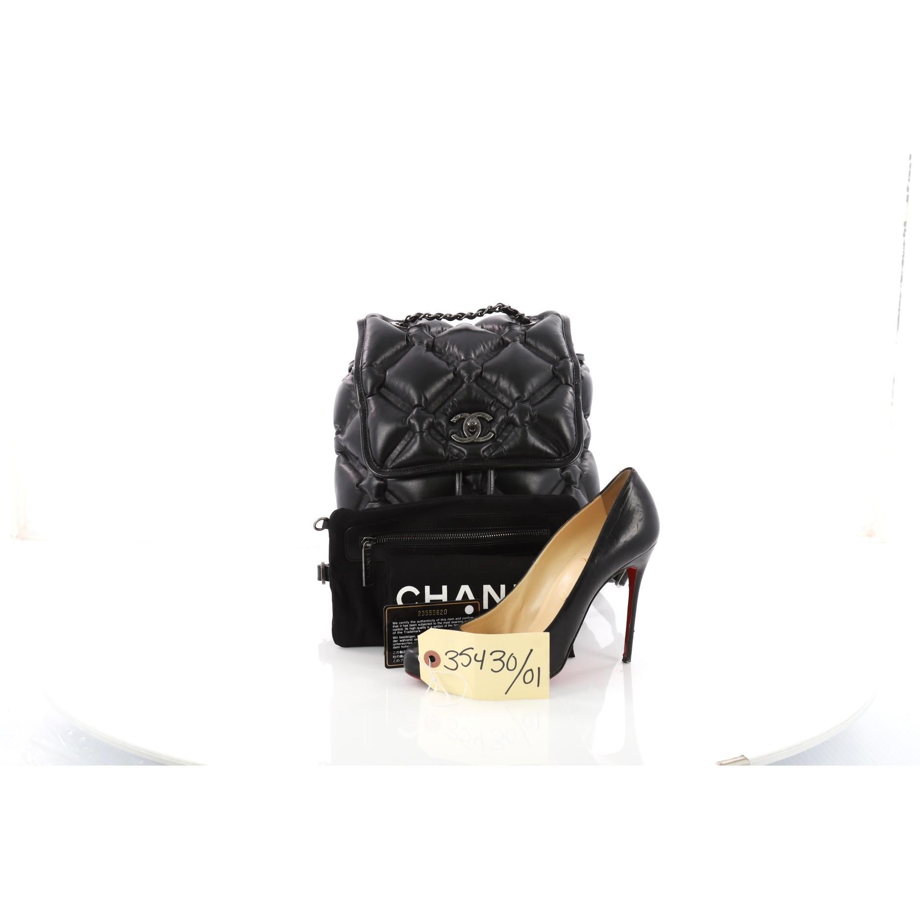 This authentic Chanel Chesterfield Backpack Quilted Calfskin Medium displays a fun and fabulous design. Crafted in black calfskin leather with an exaggerated quilted pattern, this chic backpack features woven-in leather and chain top handle, dual