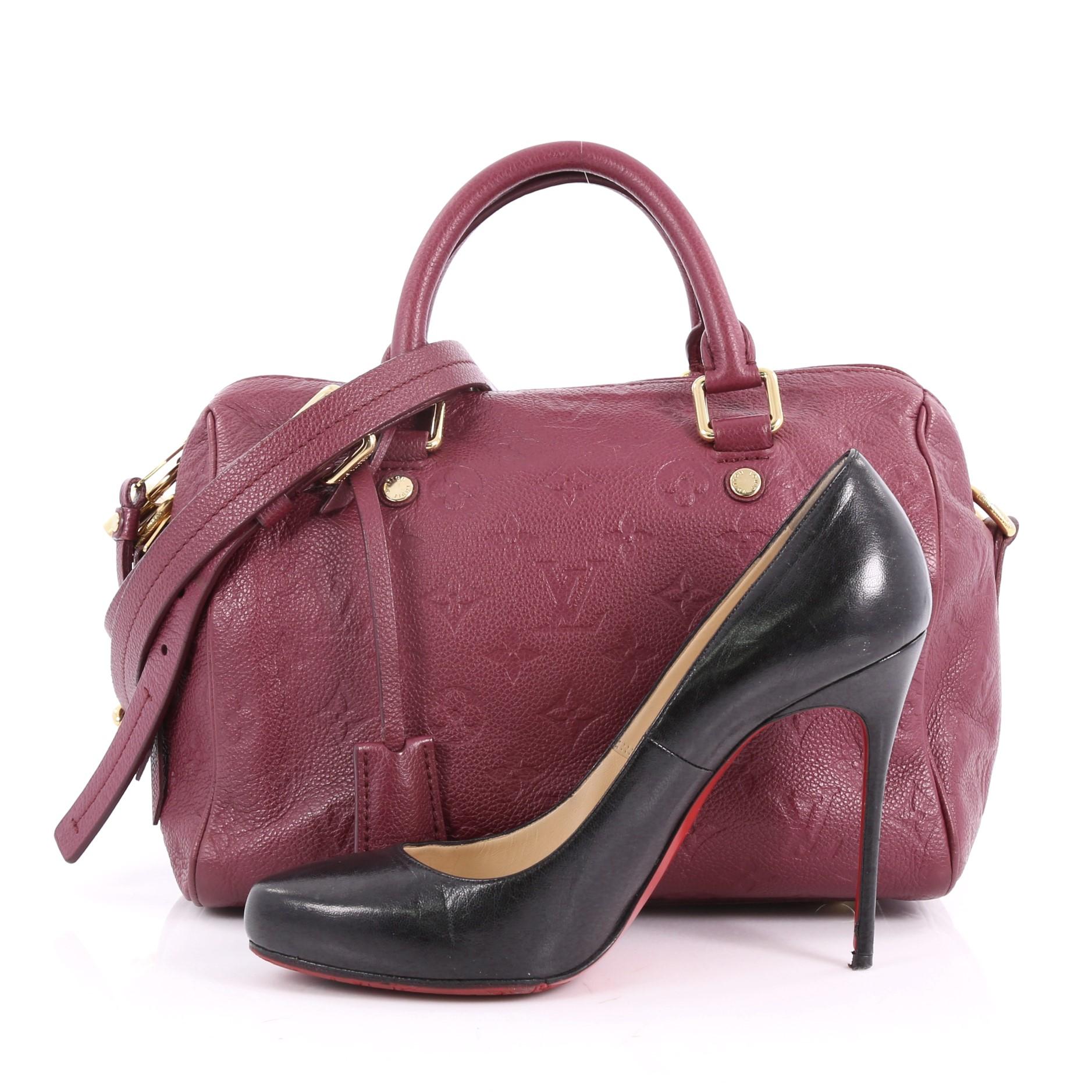 This authentic Louis Vuitton Speedy Bandouliere Bag Monogram Empreinte Leather 25 is a modern must-have. Constructed from Louis Vuitton's luxurious purple monogram embossed empreinte leather, this iconic and re-imagined Speedy features dual-rolled