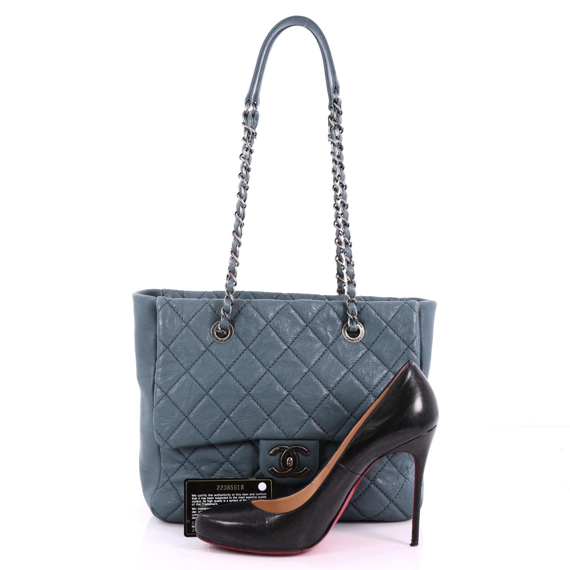 This authentic Chanel Front Flap Shopping Tote Quilted Washed Lambskin Large is a fashionable and functional everyday bag. Crafted in blue quilted washed lambskin leather, this glamorous tote features chain-link shoulder straps with leather pads, CC