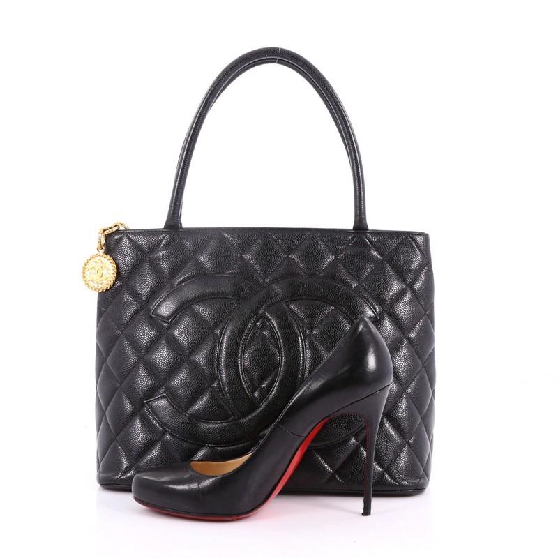 This authentic Chanel Medallion Tote Quilted Caviar is an iconic tote in a versatile sleek style that will complement a multitude of looks. Crafted from black quilted caviar leather, this tote features dual-rolled tall handles, an oversized stitched