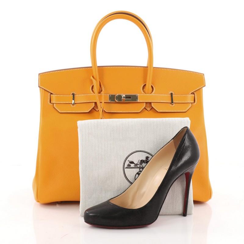 This authentic Hermes Candy Birkin Handbag Epsom 35 stands as one of the most-coveted accessory made for the modern woman. Crafted from Jaune d'Or yellow epsom leather, this stand-out tote features dual-rolled top handles, frontal flap, stand-out
