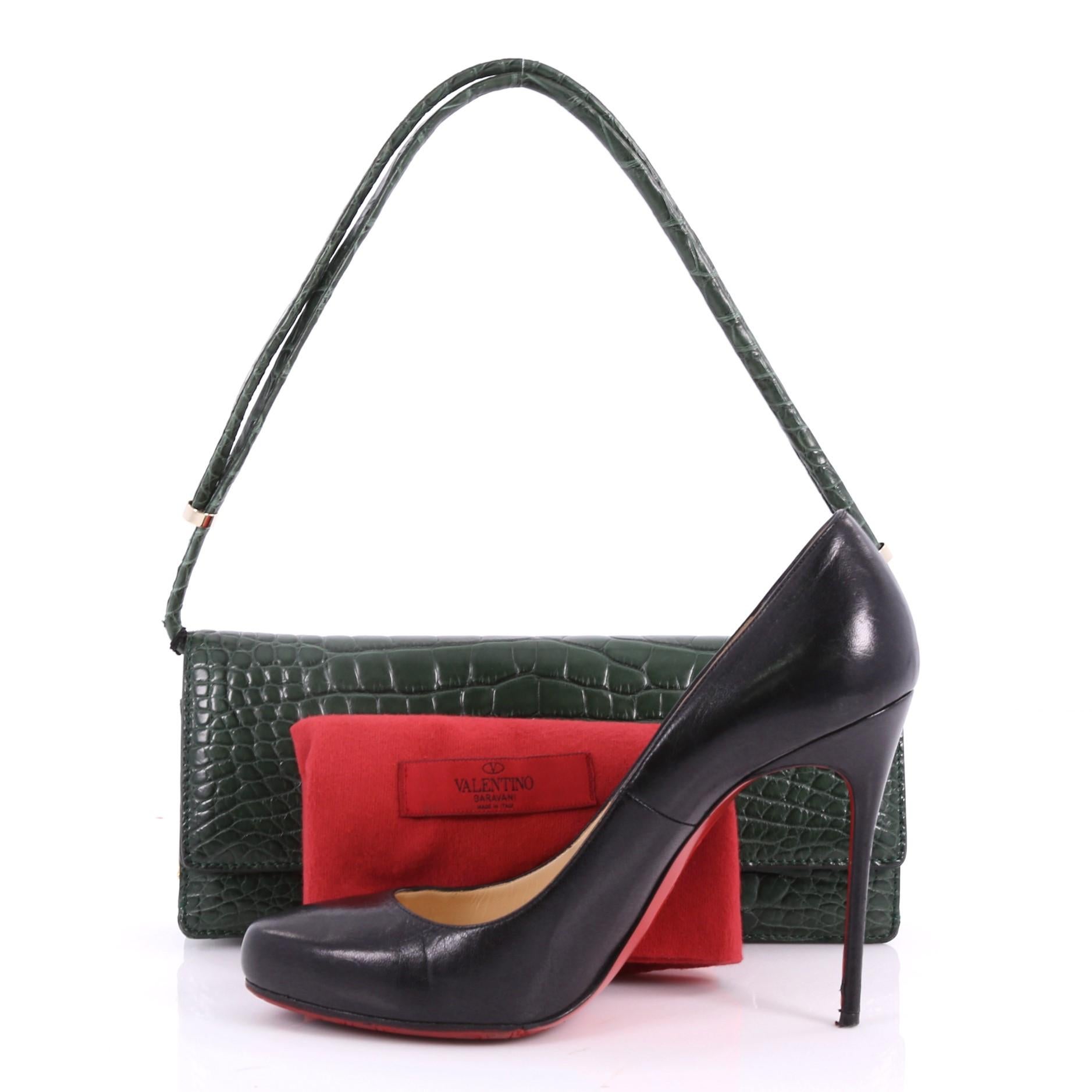 This authentic Valentino Flap Clutch Alligator Long is a sleek and beautiful clutch that will keep you organized. Crafted from genuine green alligator skin, this chic clutch features an alligator skin strap, front flap with snap closure, and