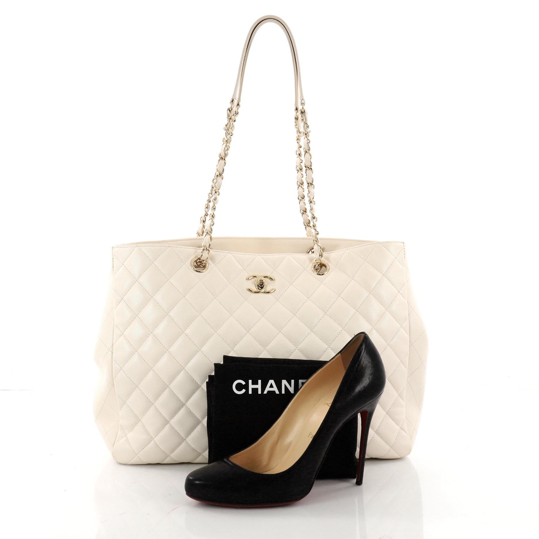 This authentic Chanel Classic CC Shopping Tote Quilted Caviar Large is the perfect companion for the modern woman. Crafted in white quilted caviar leather, this simple yet elegant tote features woven-in leather chain straps with leather shoulder