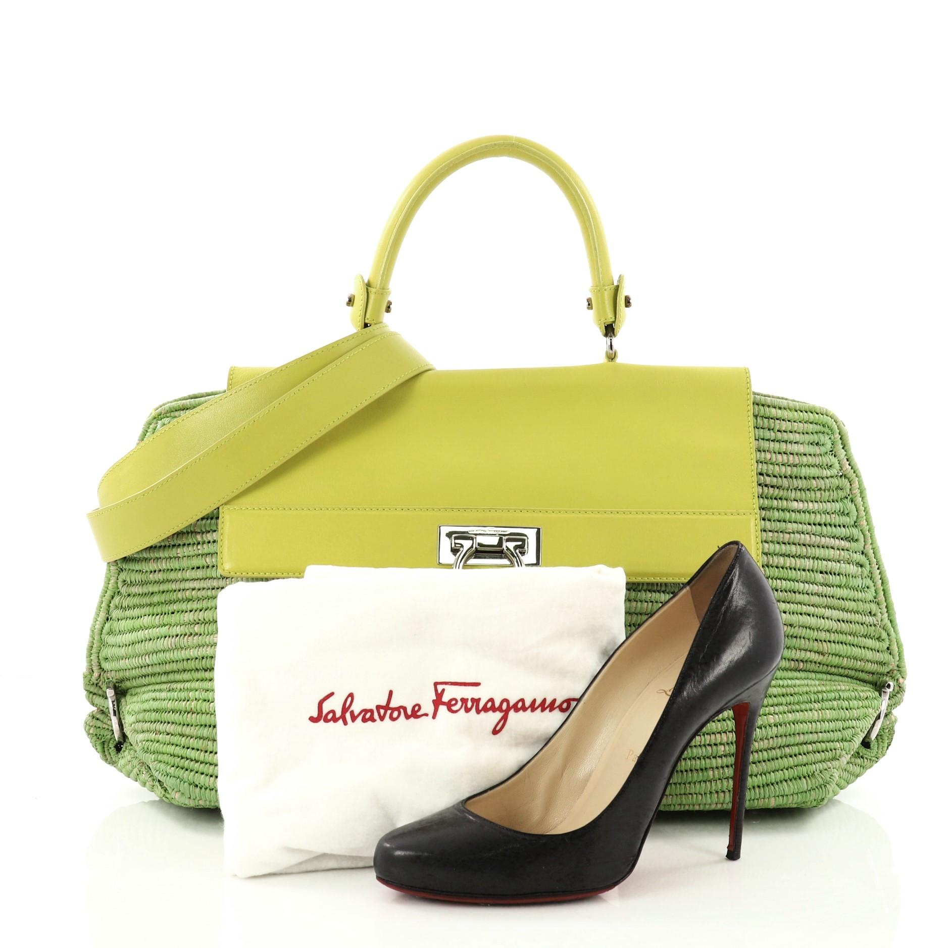 This authentic Salvatore Ferragamo Sofia Satchel Raffia with Leather Large is stylish and functional bag perfect for the modern woman. Crafted from green raffia, this bag features a sturdy top handle, leather flap, protective base studs, and