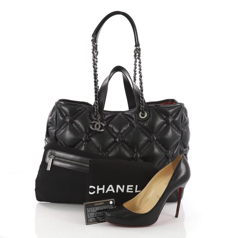This authentic Chanel Chesterfield Shopping Tote Quilted Leather Large is a unique piece perfect for everyday use. Crafted in black leather in chesterfield-style quilting, this tote features dual leather handles with chain link straps, protective
