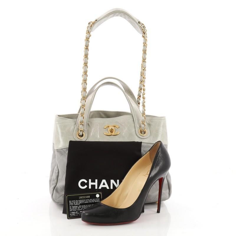 This authentic Chanel In The Mix Shopping Bag Quilted Calfskin Small is a classic yet easy style made for the modern woman. Crafted from light gray calfskin leather with glossy light grey leather top trims and handles, this versatile tote features