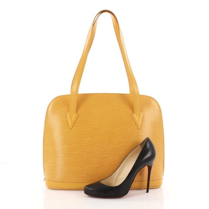 This authentic Louis Vuitton Lussac Handbag Epi Leather is a chic and sophisticated bag perfect for your everyday use. Constructed with Louis Vuitton's signature sturdy yellow epi leather, this bag features dual flat leather straps, subtle LV logo,
