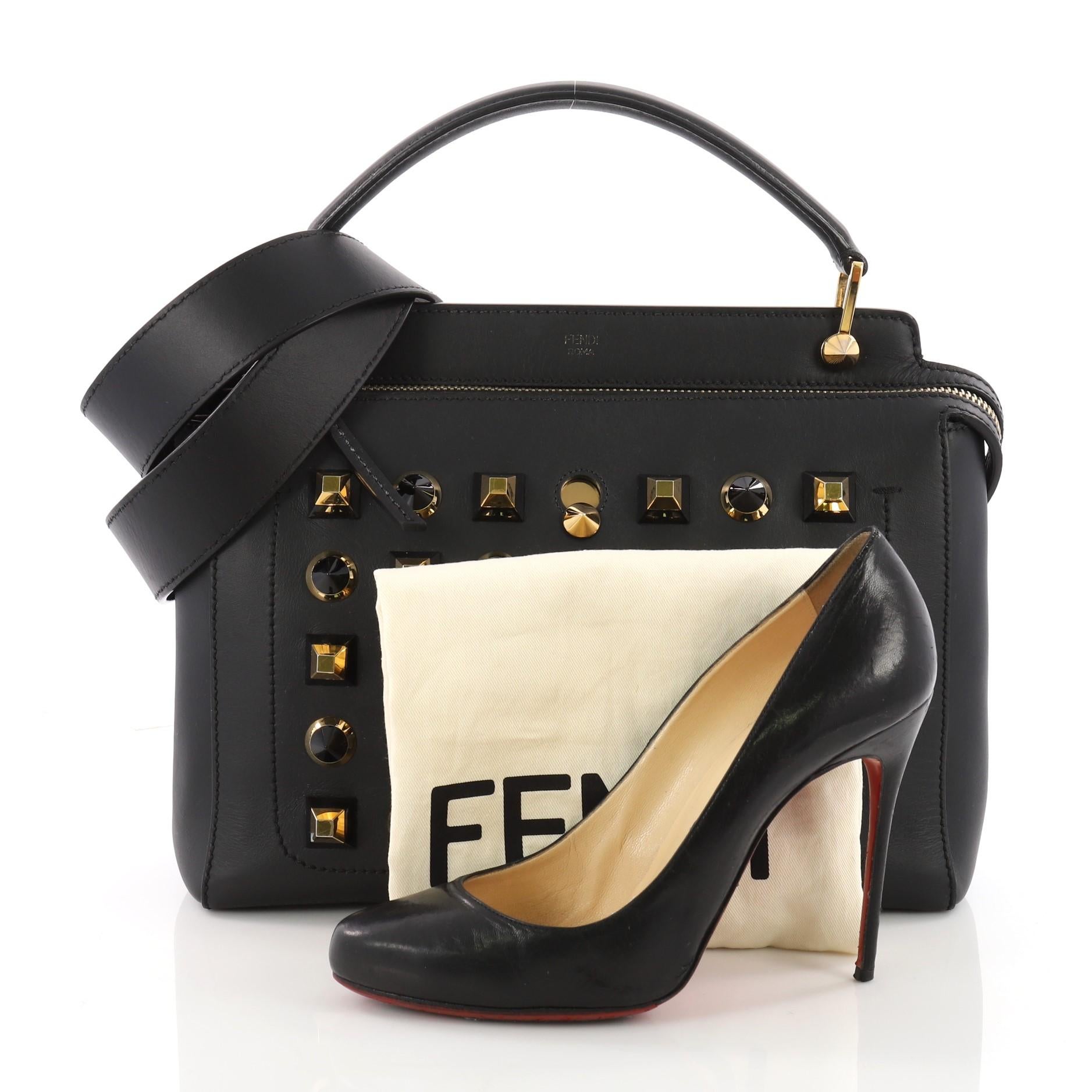 This authentic Fendi DotCom Convertible Satchel Studded Leather Medium is a chic and minimalist bag perfect for your everyday looks. Crafted from black leather, this playful satchel features a flat top handle, multiple stud detailing, distinctive