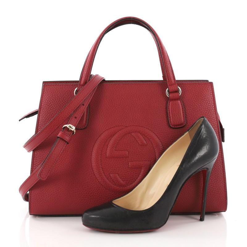 This authentic Gucci Soho Convertible Top Handle Satchel Leather Medium is an elegant design. Crafted from red leather, this bag features dual-flat leather top handles, detachable and adjustable shoulder strap, embossed interlocking GG logo, and