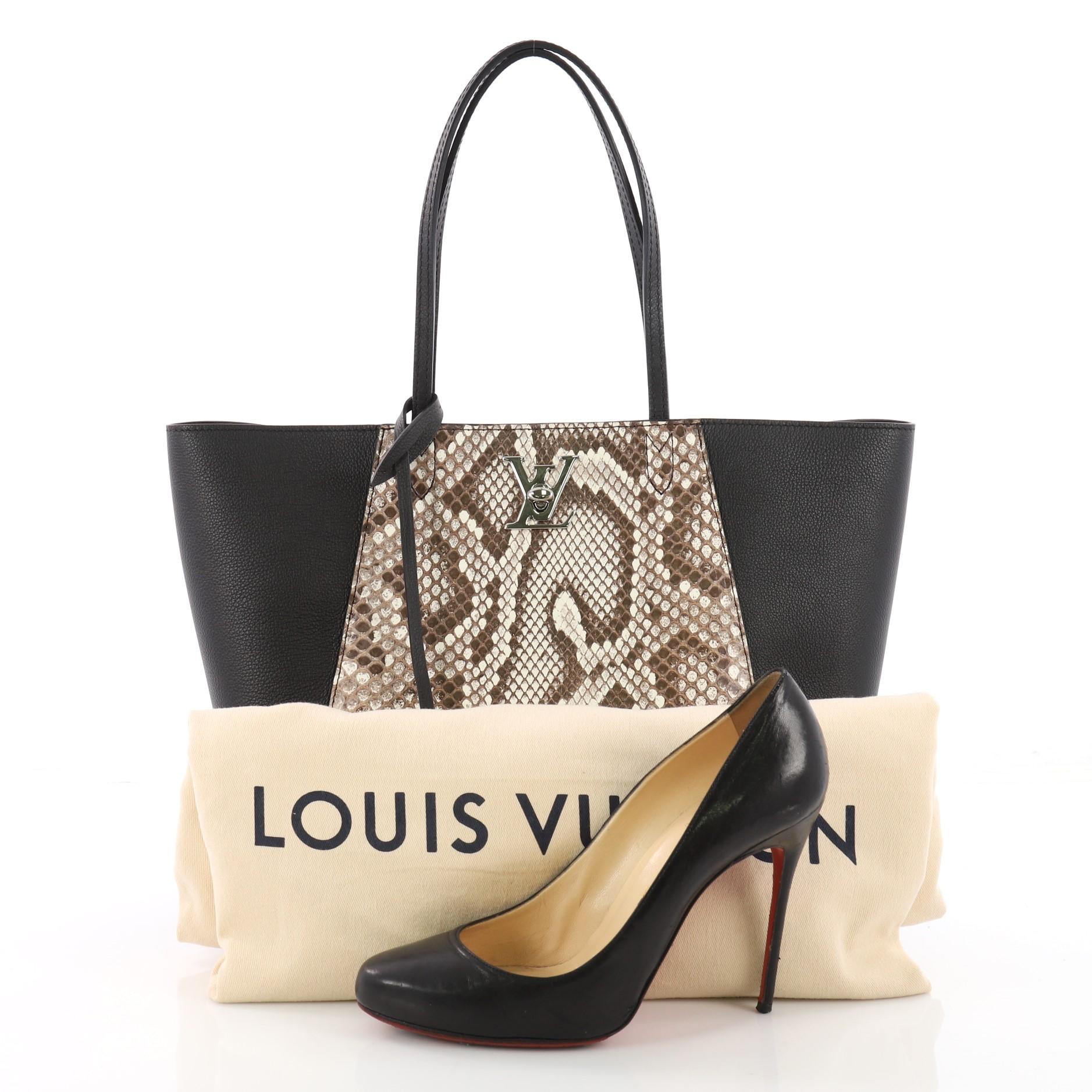 This authentic Louis Vuitton Lockme Cabas Leather and Python is a gorgeous and sophisticated bag. Crafted from black leather and genuine beige python, this bag features dual flat leather handles, LV twist closure, and silver-tone hardware accents.
