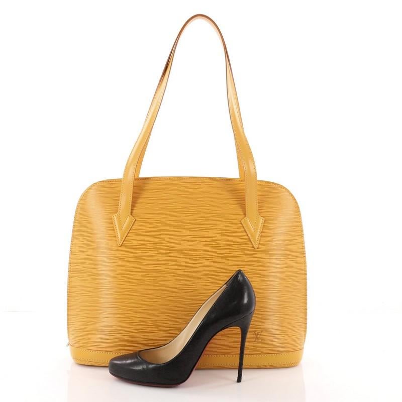 This authentic Louis Vuitton Lussac Handbag Epi Leather is a chic and sophisticated bag perfect for your everyday use. Constructed with Louis Vuitton's signature sturdy yellow epi leather, this bag features dual flat leather straps, subtle LV logo,