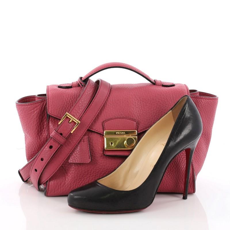 This authentic Prada Pattina Convertible Shoulder Bag Vitello Daino Medium is a sophisticated piece you can carry from day to night. Crafted from pink vitello daino leather, this compact bag features a flat top handle, exterior side pockets,