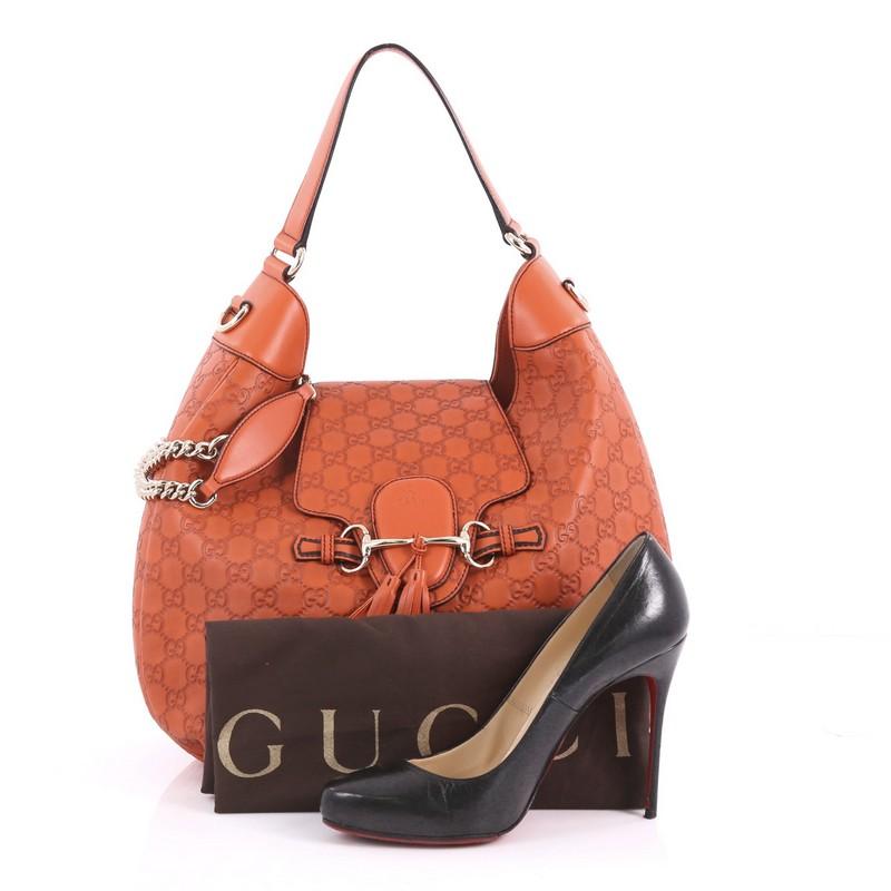 This authentic Gucci Emily Hobo Guccissima Leather Medium is a stylish accessory perfect for everyday casual looks. Crafted in orange guccissima leather, this modern-day hobo features Gucci's iconic horsebit design with leather tassels at the front,