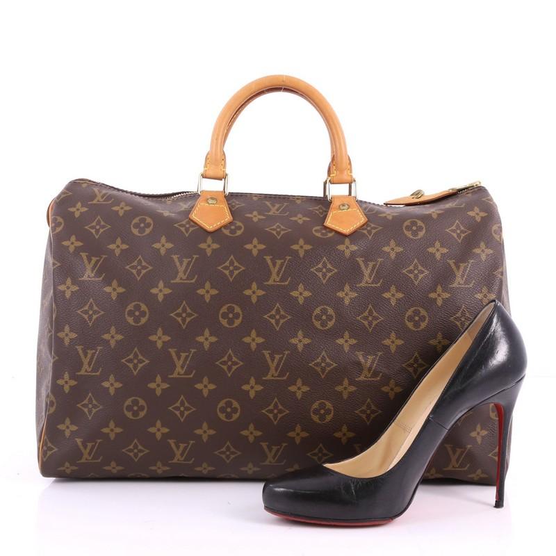 This authentic Louis Vuitton Speedy Handbag Monogram Canvas 40 is spacious and light, making it ideal to use everyday. Constructed in Louis Vuitton's classic brown monogram coated canvas, this iconic Speedy features dual-rolled leather handles,