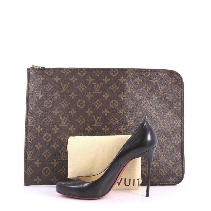 This authentic Louis Vuitton Poche Documents Monogram Canvas combines style and functionality ideal for work. Crafted with Louis Vuitton's iconic brown monogram coated canvas, this stylish portfolio clutch features gold-tone zip-around closure that