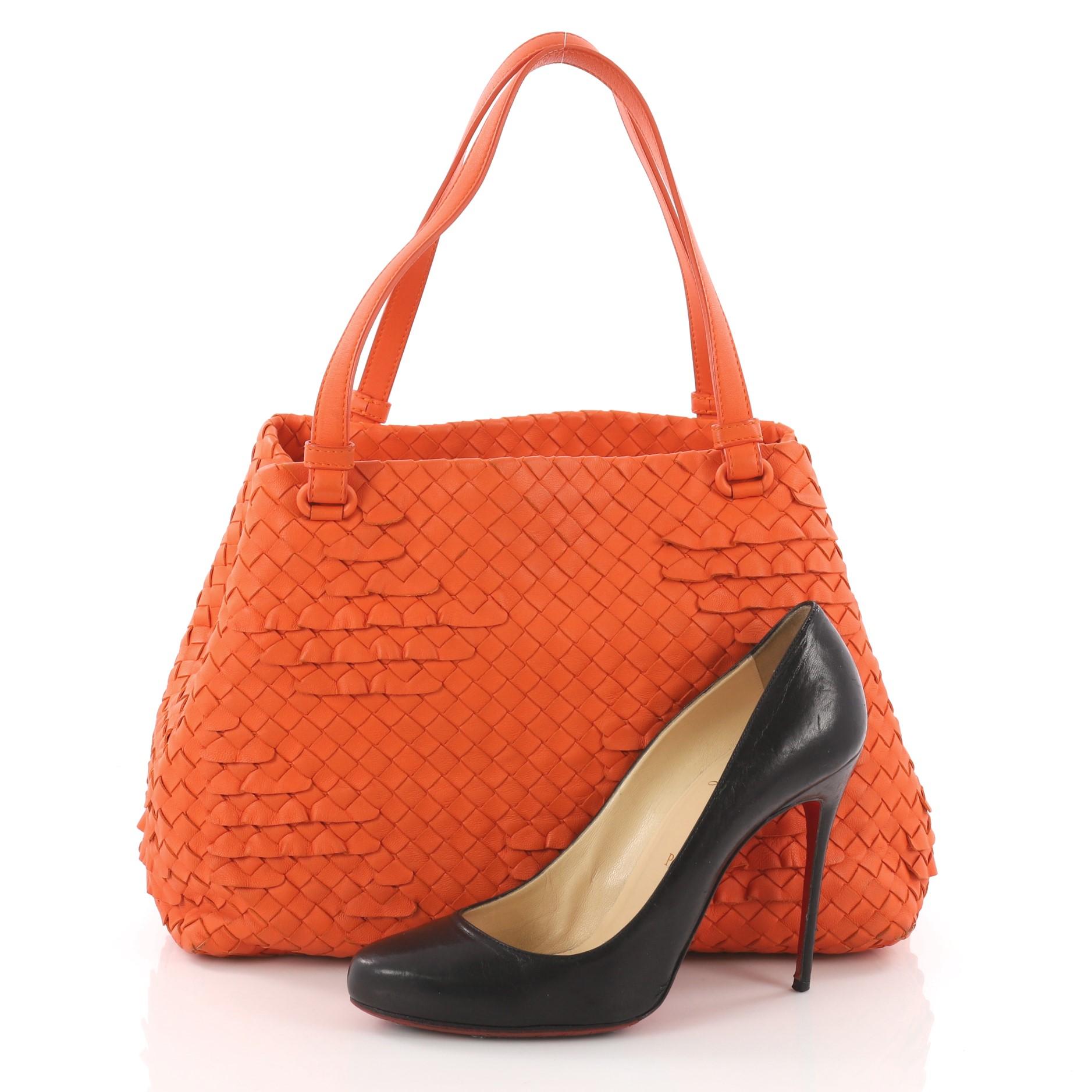 This authentic Bottega Veneta Open Tote Miniode Intrecciato Nappa Small is a statement piece you can surely take from day to night. Beautifully crafted in orange nappa leather in Bottega Veneta's signature intrecciato woven method with frilly