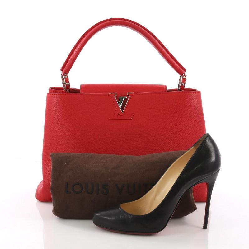 This authentic Louis Vuitton Capucines Handbag Leather MM is a sophisticated and ladylike luxurious bag inspired by its Parisian heritage. Crafted in red taurillon leather, this chic stand-out bag features a single loop leather handle secured by