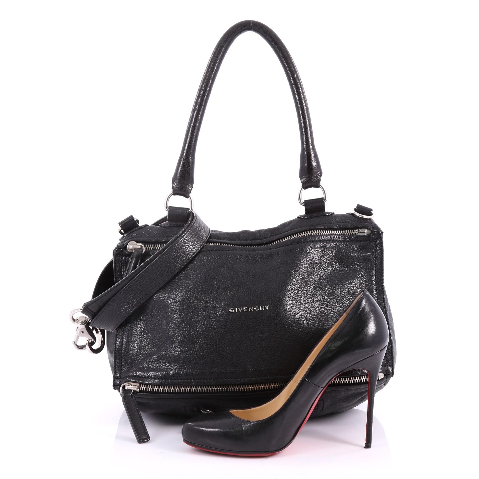This authentic Givenchy Pandora Bag Leather Medium is the perfect companion for any on-the-go fashionista. Crafted from black leather, this edgy cult-favorite satchel features a pandora box-inspired silhouette, a singular top handle, an exterior zip