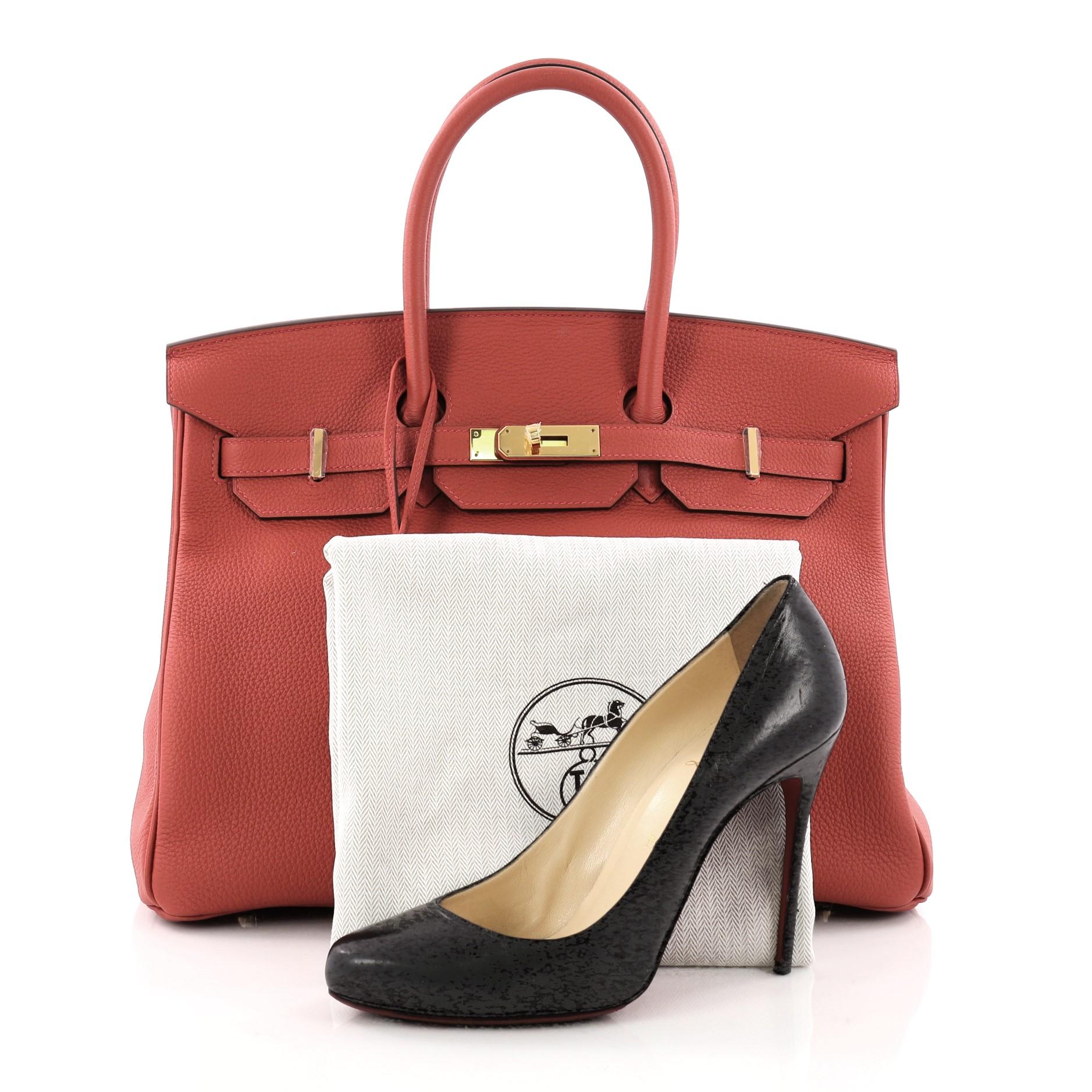 This authentic Hermes Birkin Handbag Rouge Tomate Togo with Gold Hardware 35 is synonymous to traditional Hermes luxury. Crafted with sturdy, scratch-resistant Rouge Tomate Togo leather, this eye-catching luxurious tote is accented with gold