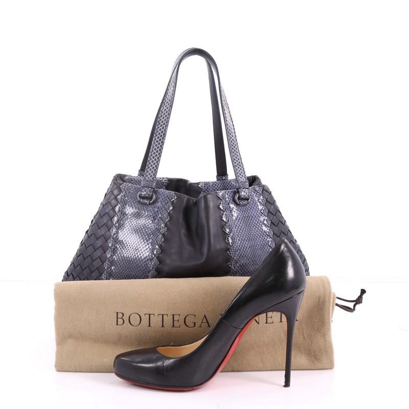 This authentic Bottega Veneta A-Shape Tote Intrecciato Nappa with Python Detail Medium is a statement piece you can surely take from day to night. Crafted in blue leather woven in Bottega Veneta's signature intrecciato method with genuine python