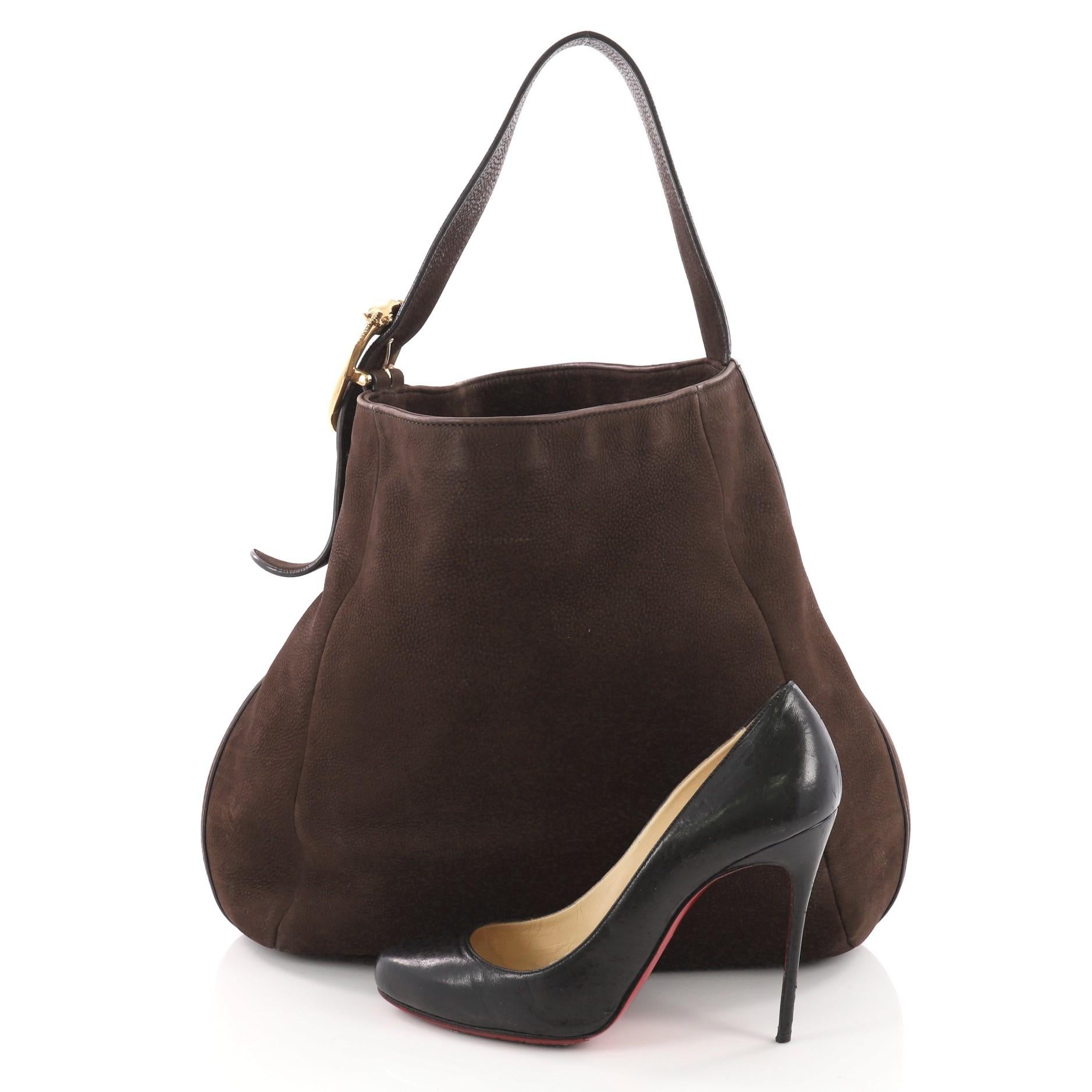 This authentic Gucci Ribot Horse Heads Hobo Nubuck Large is perfect for everyday use. Crafted from brown nubuck leather, this traditionally-shaped hobo features flat shoulder strap with double horse head buckle embellishment and gold-tone hardware