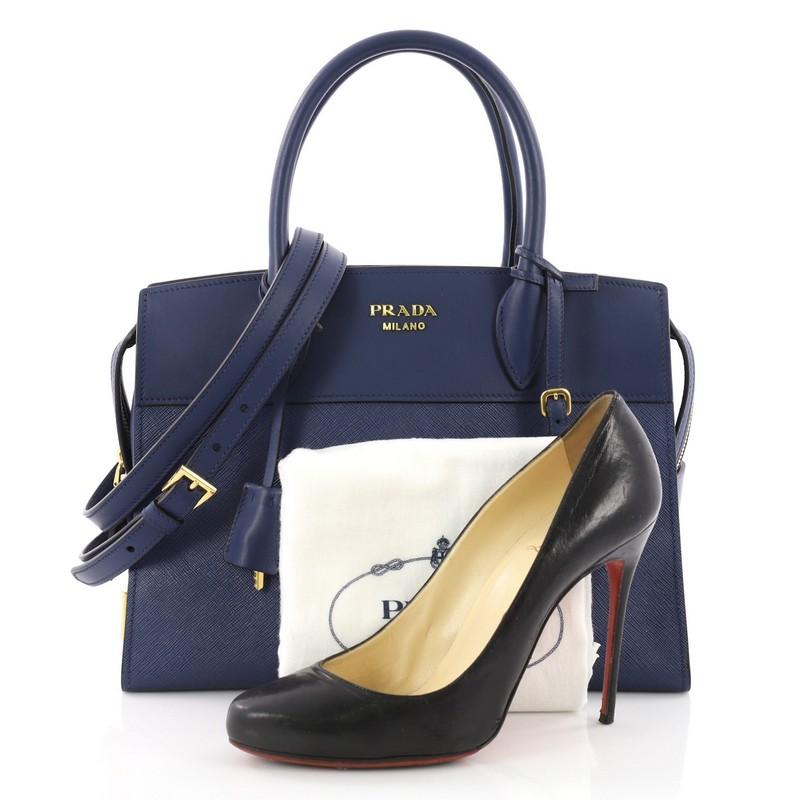 This authentic Prada Esplanade Handbag Saffiano Leather Medium is a chic bag perfect for the modern fashionista. Crafted in blue saffiano leather with blue city calf leather, this chic bag features dual-rolled leather handles, Prada metal logo