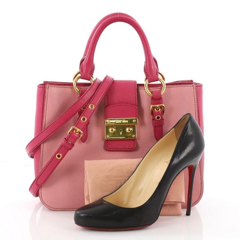 This authentic Miu Miu Madras Convertible Lock Tote Leather Small showcases a chic and stylish design perfect for everyday use. Crafted from pink madras leather, this sophisticated tote features dual-rolled handles with belted accents and gold-tone