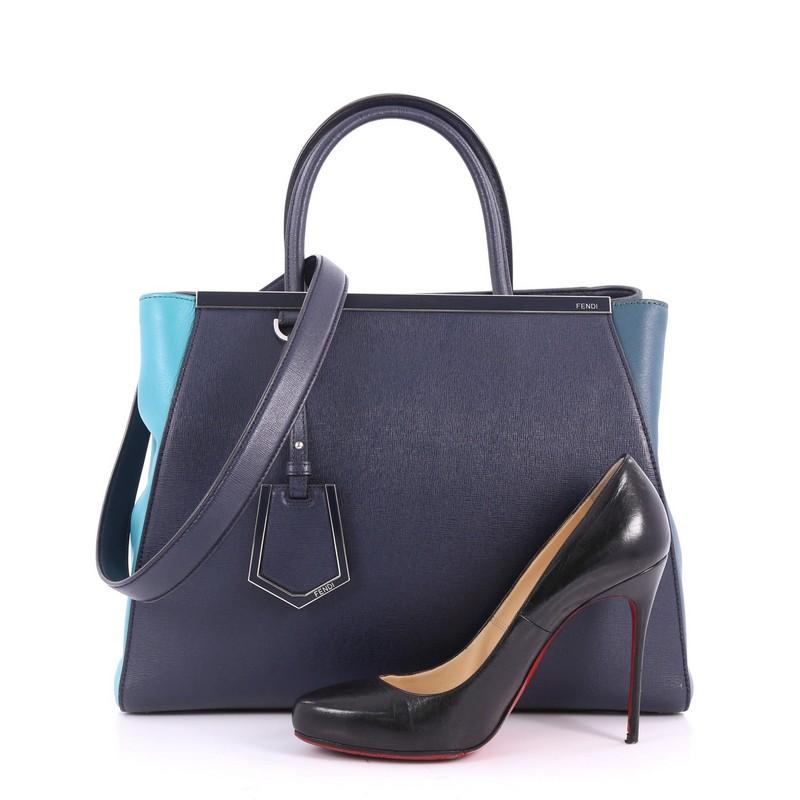 This authentic Fendi 2Jours Handbag Leather Medium, crafted in blue leather, features leather handles, expanded wings, protective base studs and silver-tone hardware accents. Its magnetic snap closure opens to a blue fabric-lined interior with zip