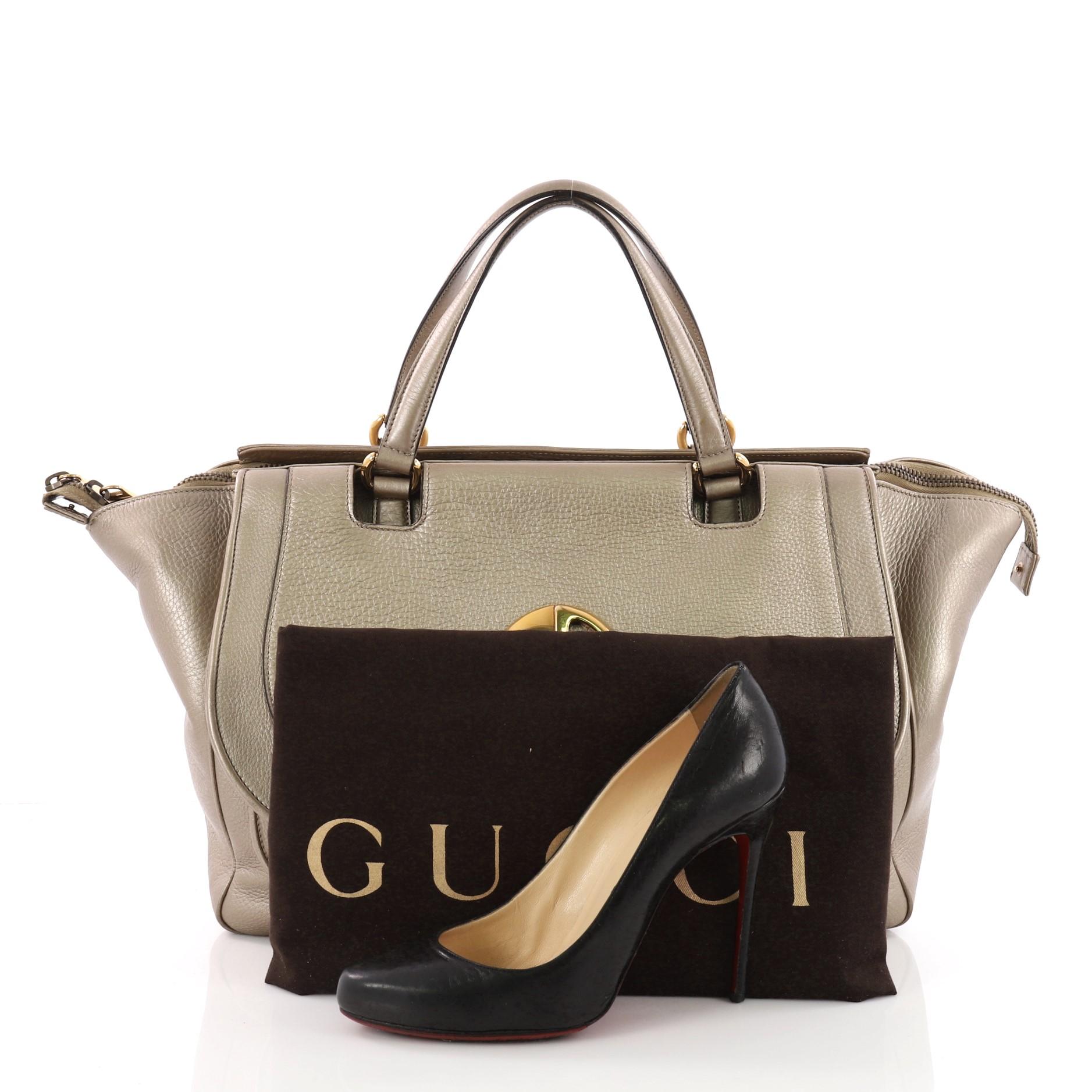 This authentic Gucci 1973 Top Handle Bag Leather Medium inspired by its 1973 classic design mixes a casual design with a modern twist. Crafted from metallic bronze leather, this bag features dual flat leather handles, vintage-style GG logo on the