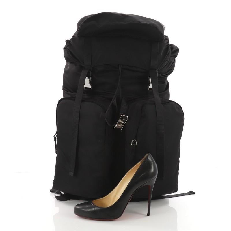 This authentic Prada Double Pocket Buckle Backpack Tessuto Large is a stylish bag perfect for on-the-go moments. Crafted in black tessuto, this backpack features a top carry handle, adjustable back shoulder straps, double-buckle flap, two exterior