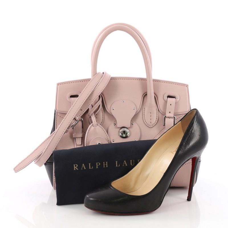 This authentic Ralph Lauren Collection Soft Ricky Handbag Leather 27 is one of the brand's most beloved styles. Crafted from blush pink and black leather, this understated tote features a boxy silhouette, a folded top with a slide-lock clasp and