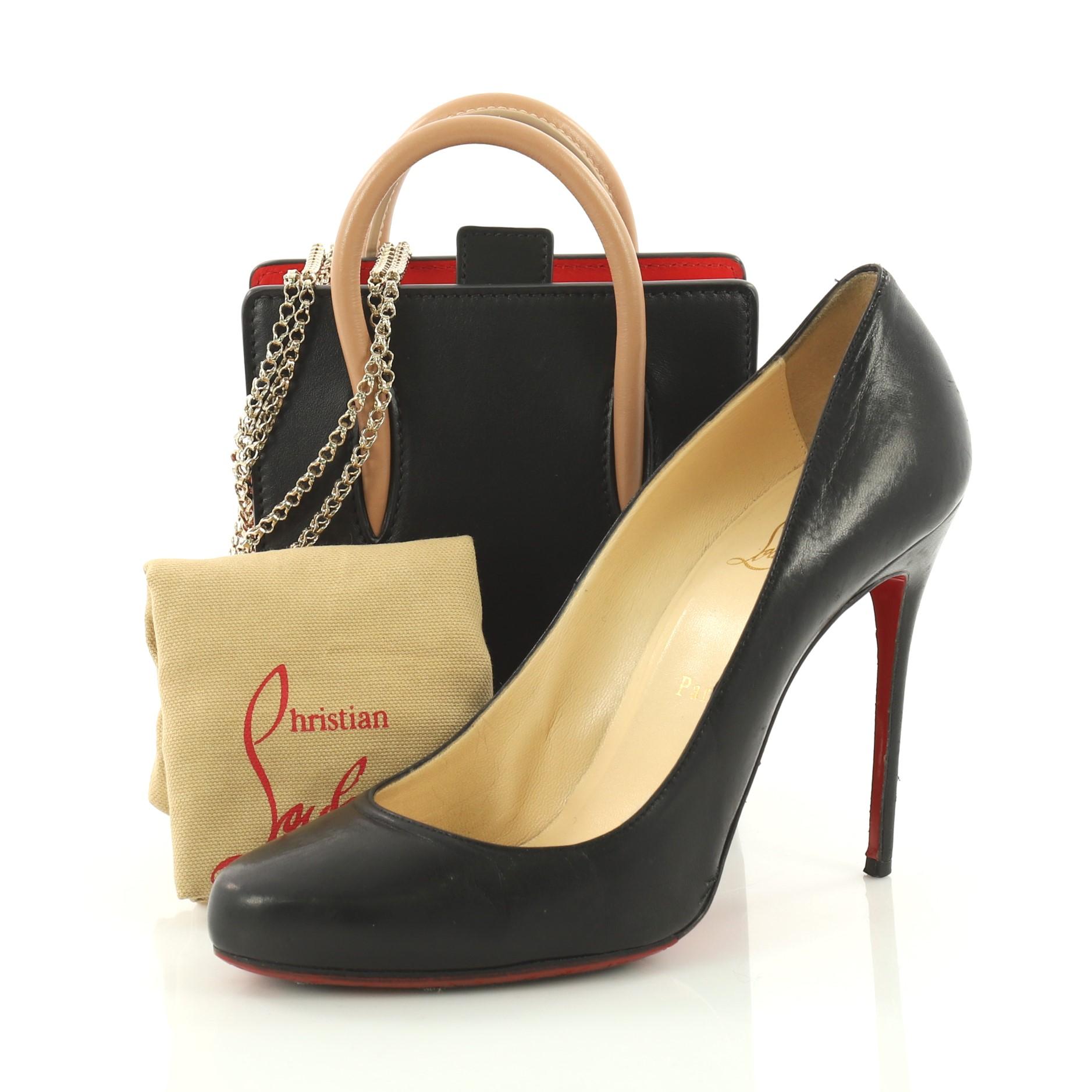 This authentic Christian Louboutin Paloma Tote Leather Nano is a unique piece made for avant-garde fashionistas. Crafted in black leather, this stand-out daring bag features spiked leopard print on the sides, tall dual-rolled leather handles,