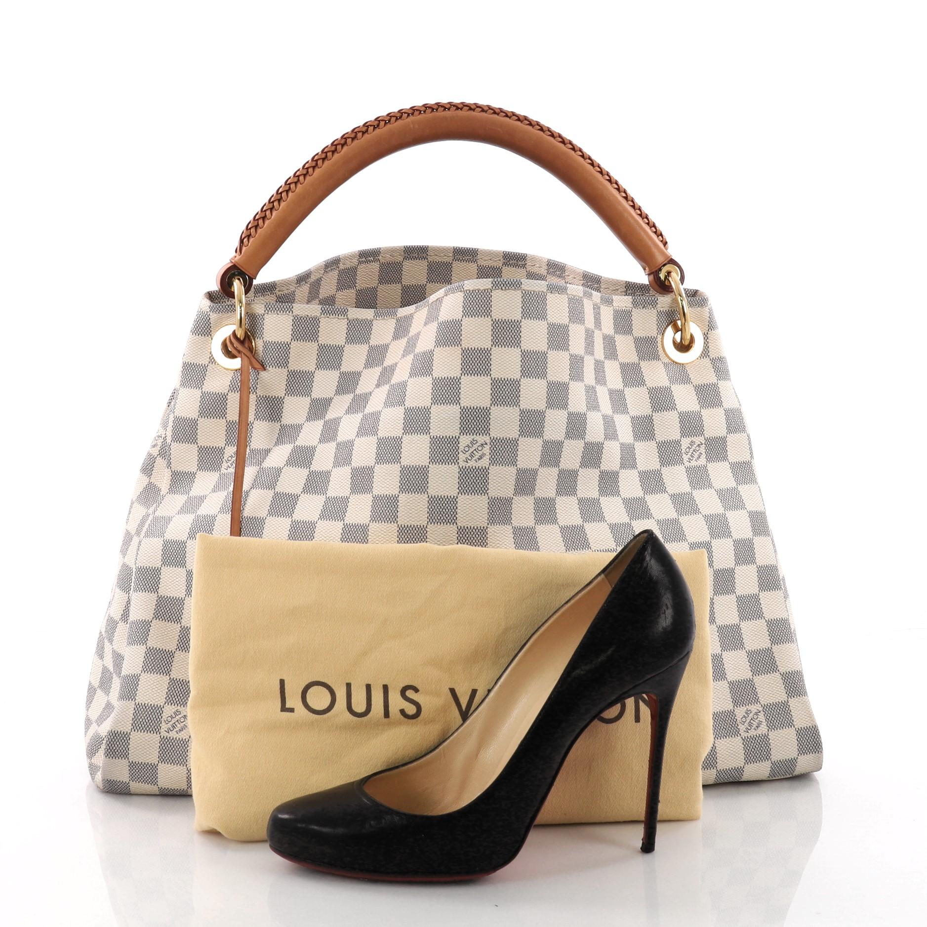 This authentic Louis Vuitton Artsy Handbag Damier MM is an elegant and iconic bag that adds a stylish flair to any outfit. Crafted from Louis Vuitton's damier azur coated canvas, this Artsy hobo features single looped hand-crafted leather handle,