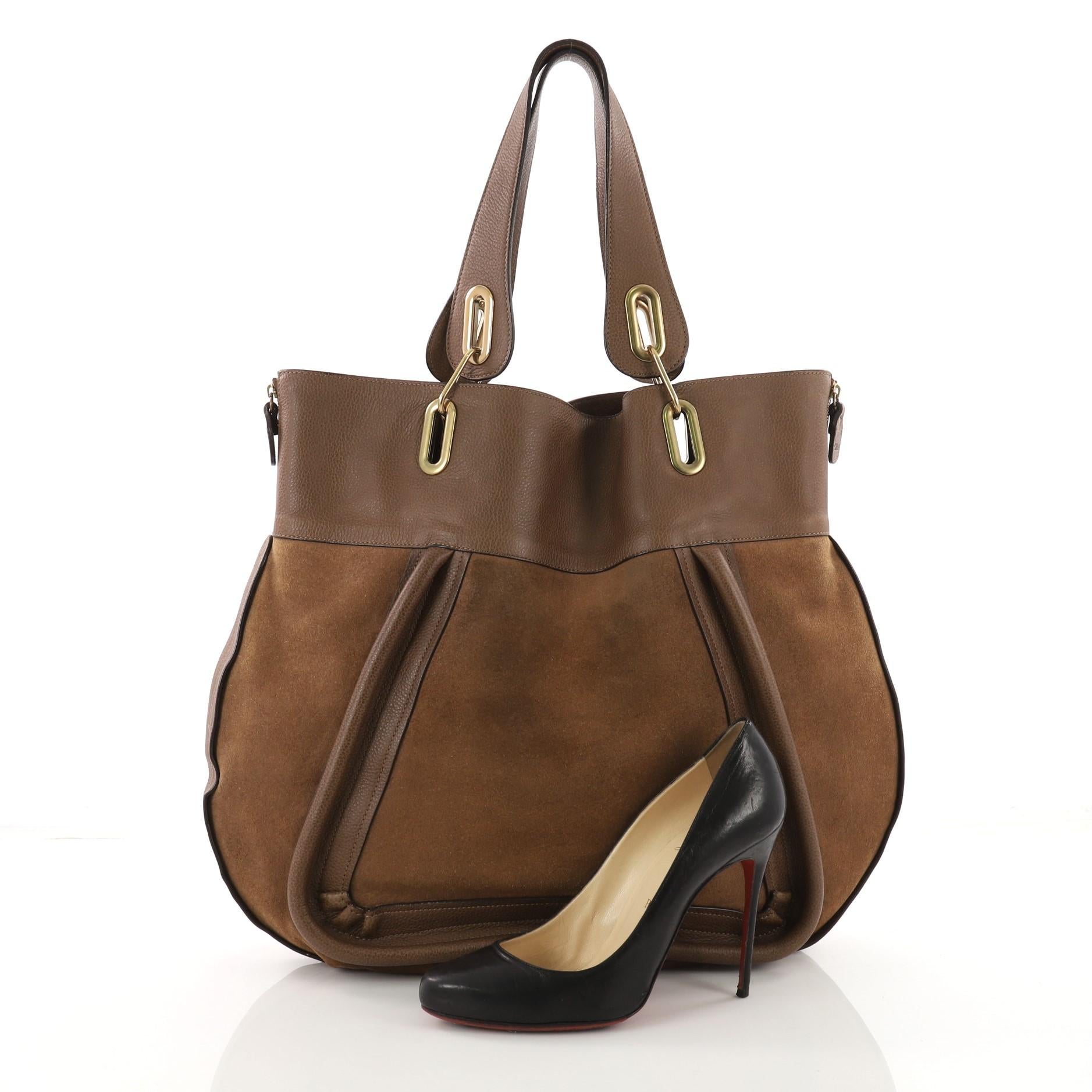 This authentic Chloe Paraty Side Zip Tote Suede with Leather Large mixes everyday style and functionality perfect for the modern woman. Crafted from brown suede with leather, this versatile bag features dual flat handles, piped trim details, side