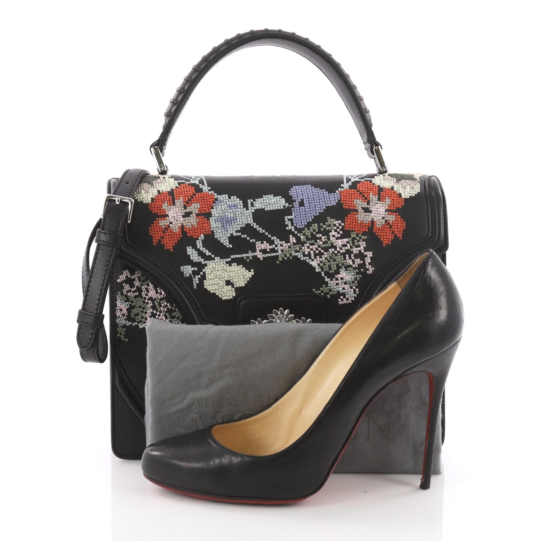 This authentic Alexander McQueen Flower Satchel Embroidered Leather Medium will definitely add a touch of sartorial edge to any outfit. Crafted in black leather, this satchel features a leather top handle, leather strap, embroidered floral detailing