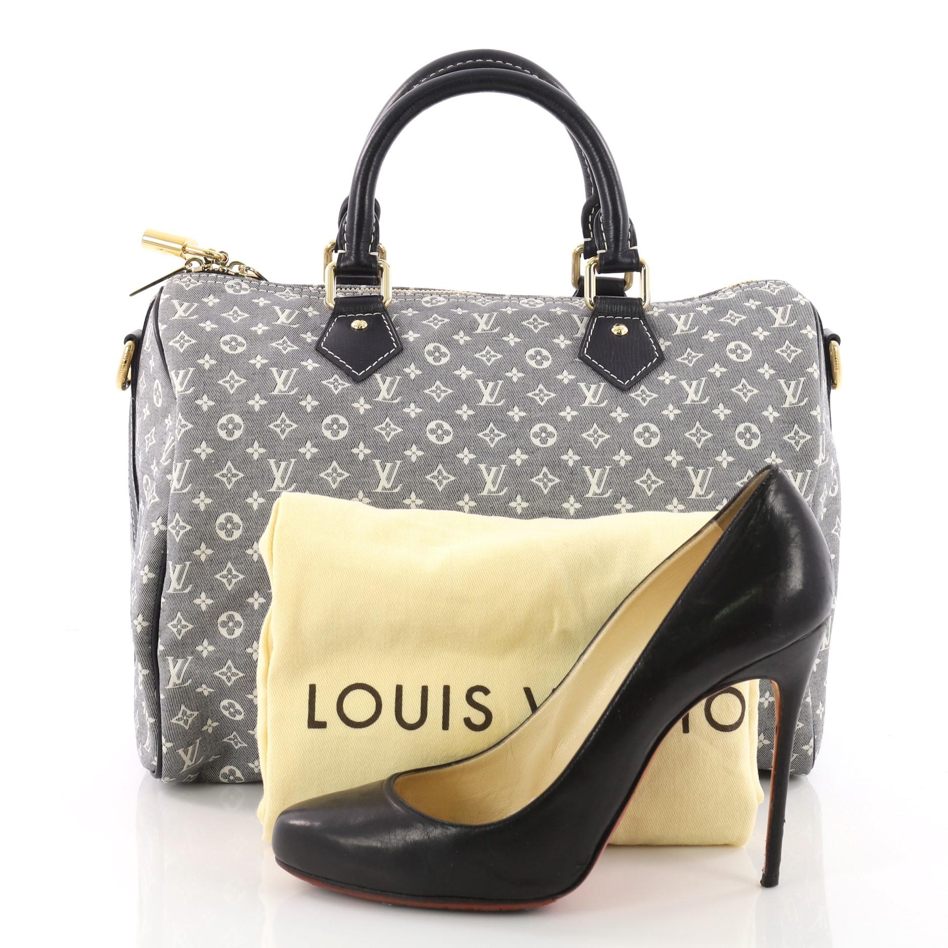 This authentic Louis Vuitton Speedy Bandouliere Bag Monogram Idylle 30 is a classic must-have. Constructed from Louis Vuitton's blue idylle monogram canvas, this fresh Speedy features dual rolled top handles, leather trims, and gold-tone hardware