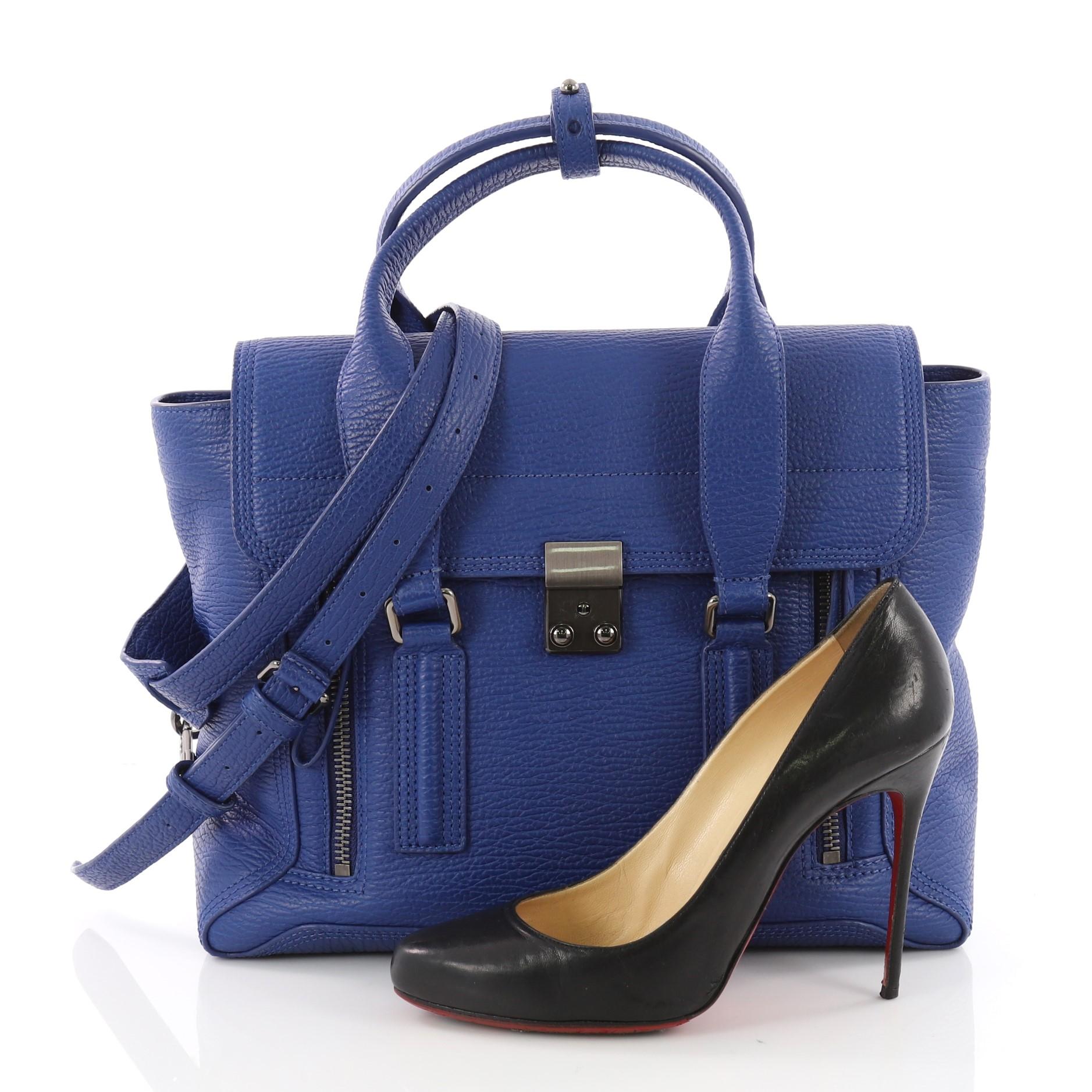 This authentic 3.1 Phillip Lim Pashli Satchel Leather Medium is a practical bag with a stylish edge made for on-the-go moments. Crafted from blue leather, this chic satchel features dual top handles, expandable zip sides, top flap push-lock closure