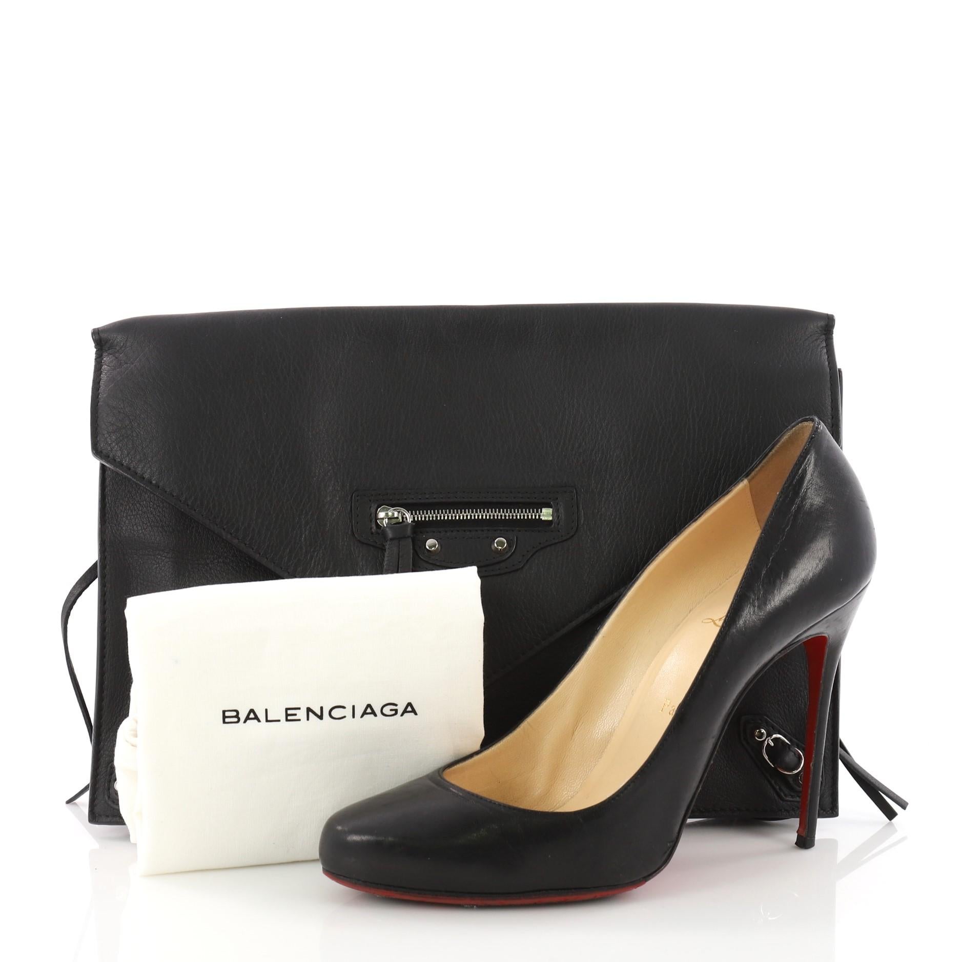 This authentic Balenciaga Papier Sight Clutch Classic Studs Leather showcases an elegant yet edgy style perfect for day-to-evening looks. Constructed in black leather, this chic clutch features Balenciaga's signature classic studs and buckle detail,