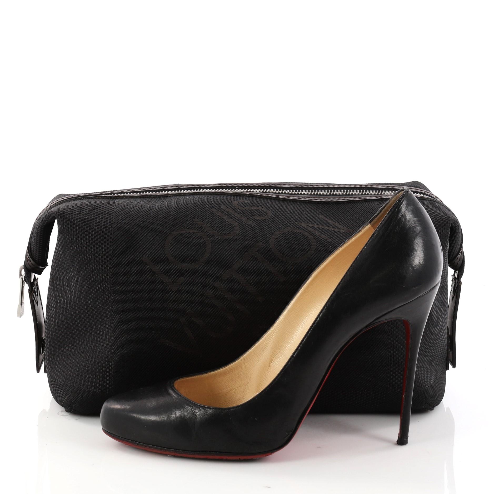 This authentic Louis Vuitton Geant Albatros Toiletry Bag Limited Edition Canvas is a stylish bag perfect for the chic and sophisticated. Crafted in black damier geant canvas, this sleek bag features brown leather trims, snap tabs on the sides and