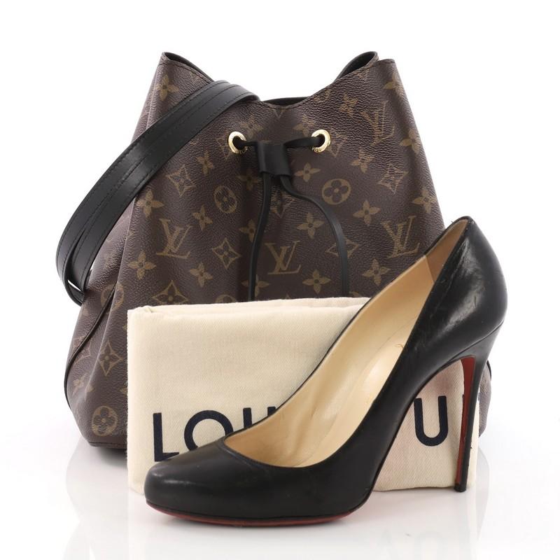 This Louis Vuitton Neonoe Handbag Monogram Canvas, crafted from brown monogram coated canvas, features long shoulder strap, black leather trims and gold-tone hardware. Its drawstring cinch closure opens to a black microfiber-lined interior divided
