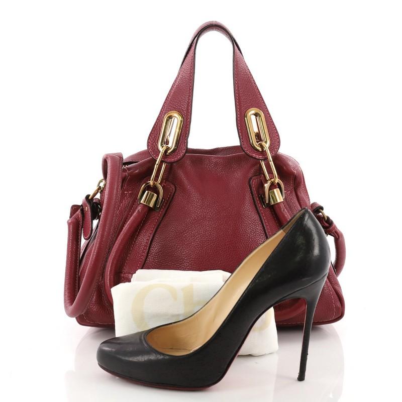 This Chloe Paraty Top Handle Bag Leather Small, crafted from magenta leather, features dual flat handles, piped trim details, and gold-tone hardware. Its top zip closure opens to a beige fabric interior with side zip pocket. **Note: Shoe
