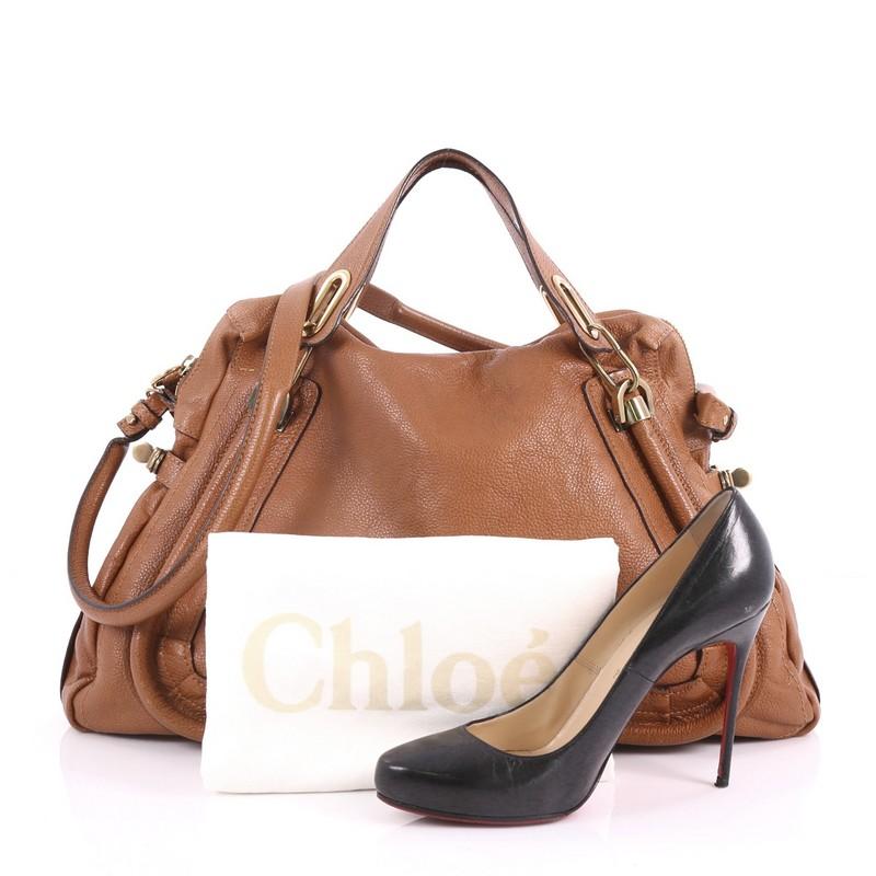 This Chloe Paraty Top Handle Bag Leather Large, crafted in brown leather, features piped trim details, dual flat handles, and gold-tone hardware. Its top zip closure opens to a beige fabric interior with zip and slip pockets. **Note: Shoe