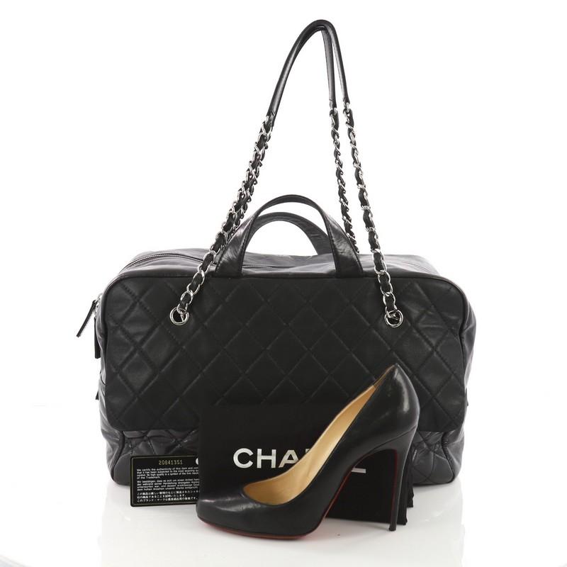 This Chanel Duo Color Front Flap Satchel Quilted Glazed and Iridescent Calfskin Large, crafted from black quilted glazed and iridescent calfskin leather, features dual flat leather handles and chain-link shoulder strap, exterior front flap pocket,