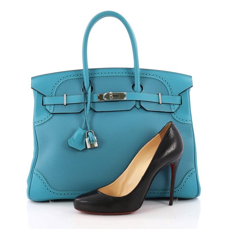 This authentic Hermes Birkin Ghillies Handbag Turquoise Togo and Swift with Palladium Hardware 35 is a special edition piece that graces only a few closets. Crafted from Turquoise Togo and Swift leather, this coveted Birkin features dual-rolled