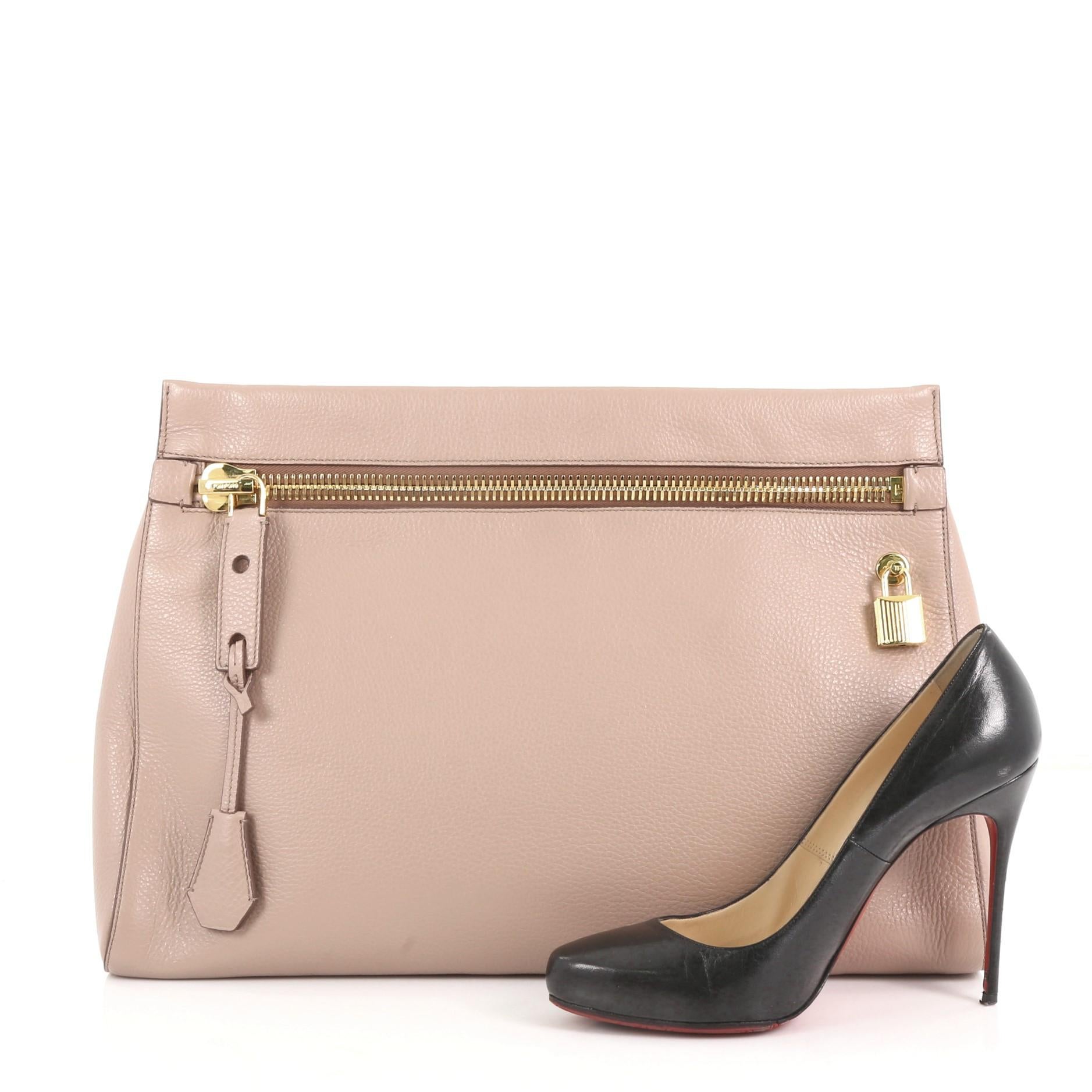 This Tom Ford Alix Clutch Leather Small, crafted from mauve leather, features an exterior zip pocket and gold-tone hardware. Its magnetic snap closure opens to a brown microfiber interior with zip and slip pockets. **Note: Shoe photographed is used