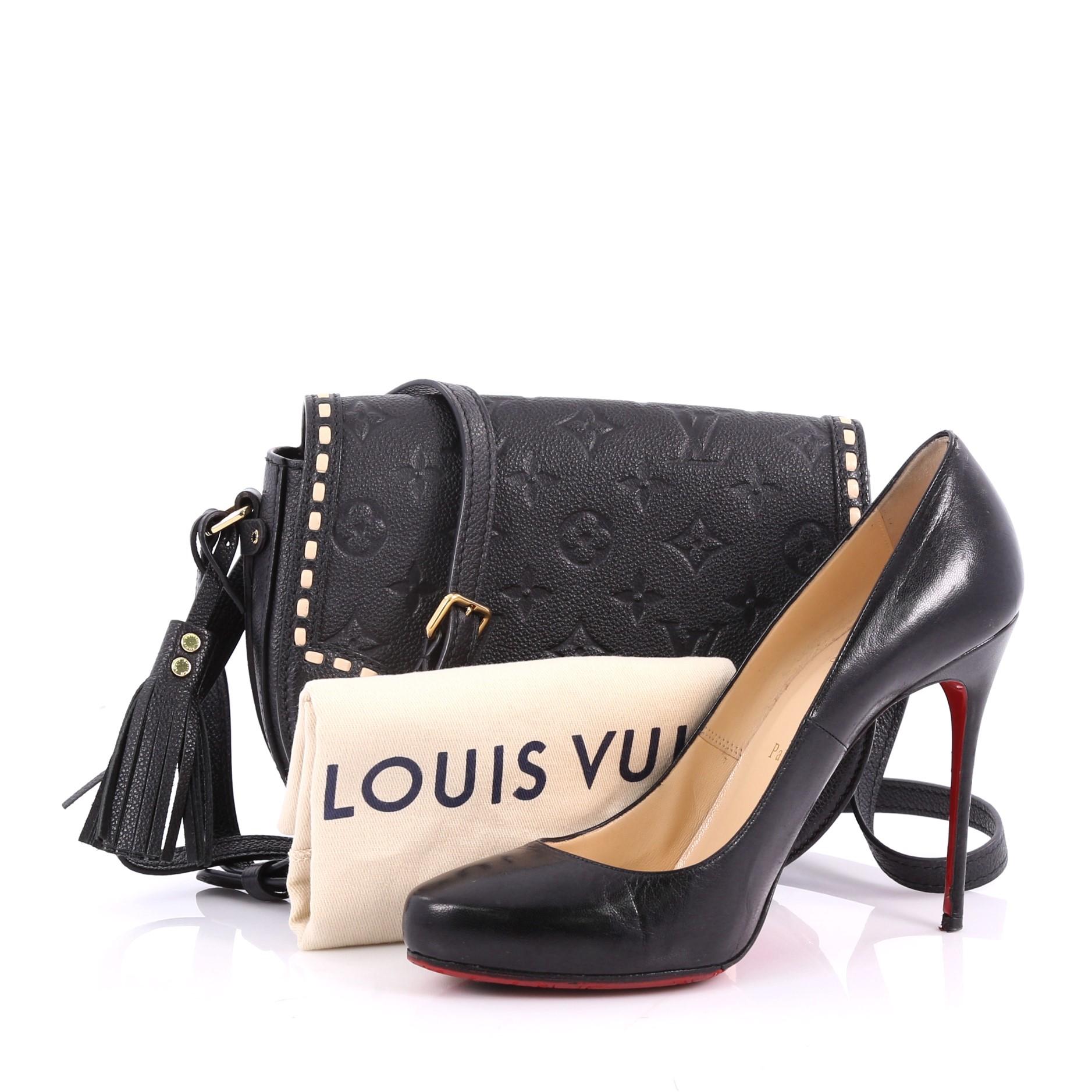 This authentic Louis Vuitton Junot Handbag Monogram Empreinte Leather is a stylish crossbody bag. Crafted in black monogram empreinte leather, this bag features adjustable shoulder strap, leather stitched detailing, front flap with push-lock closure