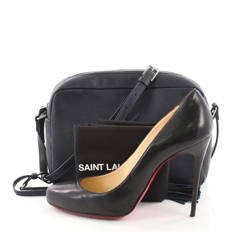 This authentic Saint Laurent Lou Camera Bag Leather Small showcases a minimalist and chic silhouette. Crafted from navy leather, this small crossbody features a commanding YSL monogram logo at the front, a long leather strap, and silver-tone