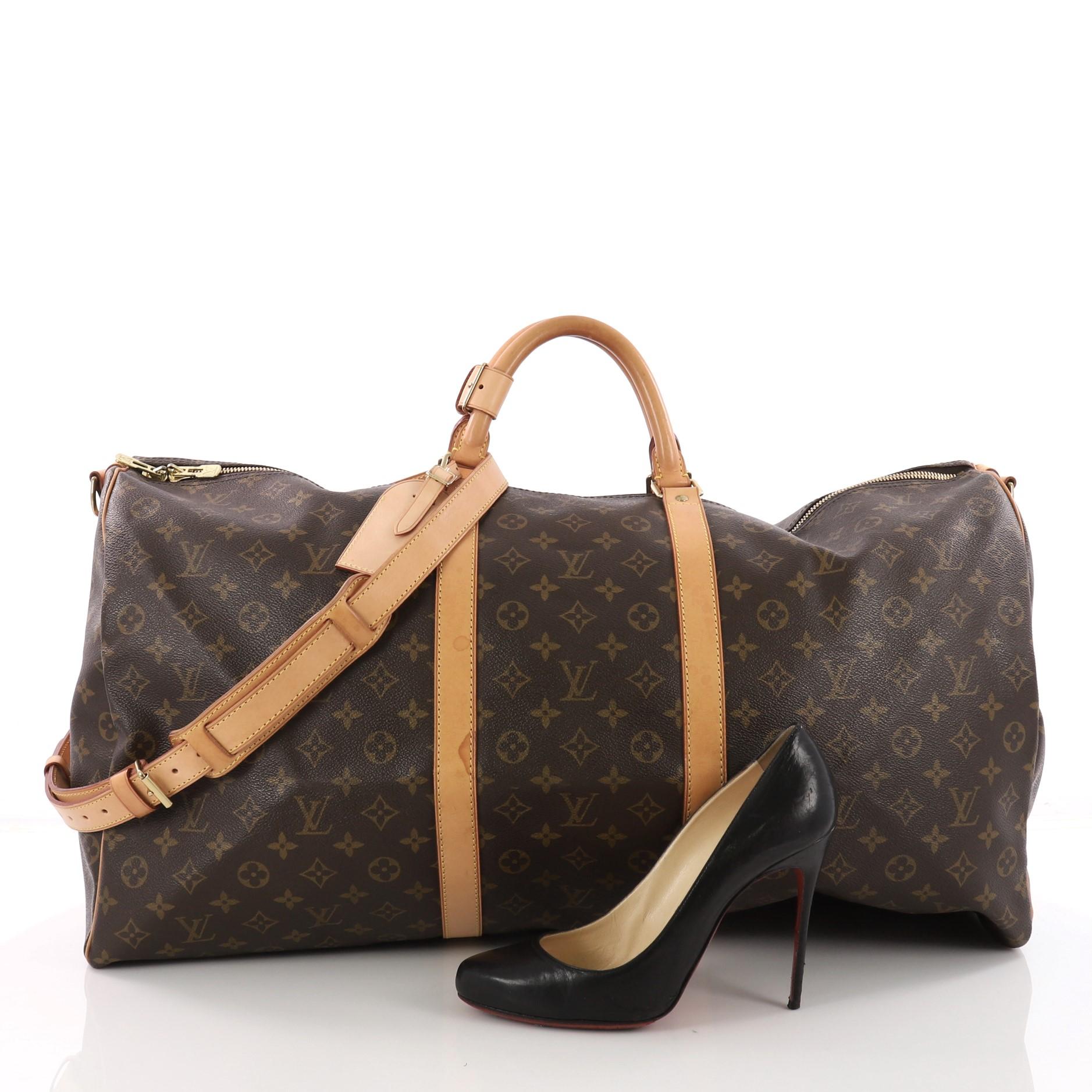 This Louis Vuitton Keepall Bandouliere Bag Monogram Canvas 60, crafted with brown monogram coated canvas, features dual-rolled handles, natural cowhide leather trims and gold-tone hardware accents. Its top zip closure opens to a brown fabric